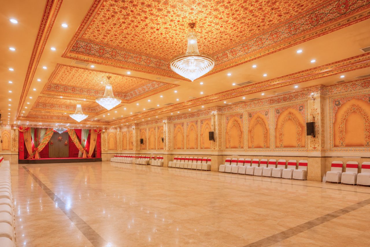 Ashoka Banquet Hall with theatre-style seating and decorated stage at Fort Chandragupt Hotel Jaipur