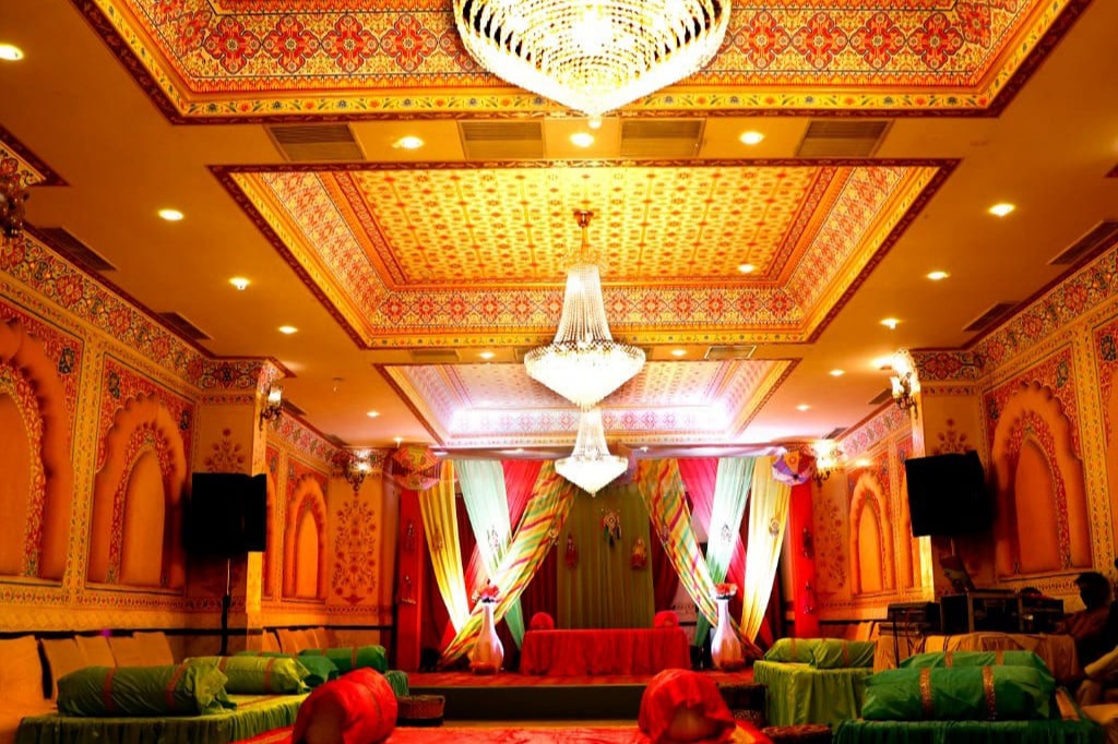 Banquet hall decorated with colorful drapes for a wedding function at Fort Chandragupt Hotel Jaipur
