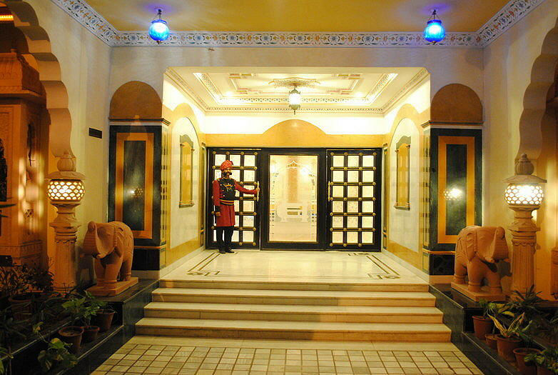 Grand entrance lobby with doorman and elephant statues at Fort Chandragupt Hotel Jaipur