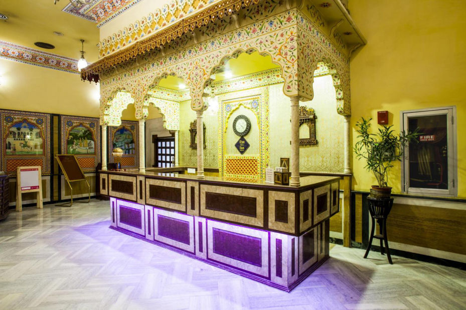 Ornately decorated lobby reception desk at Fort Chandragupt Hotel, Jaipur