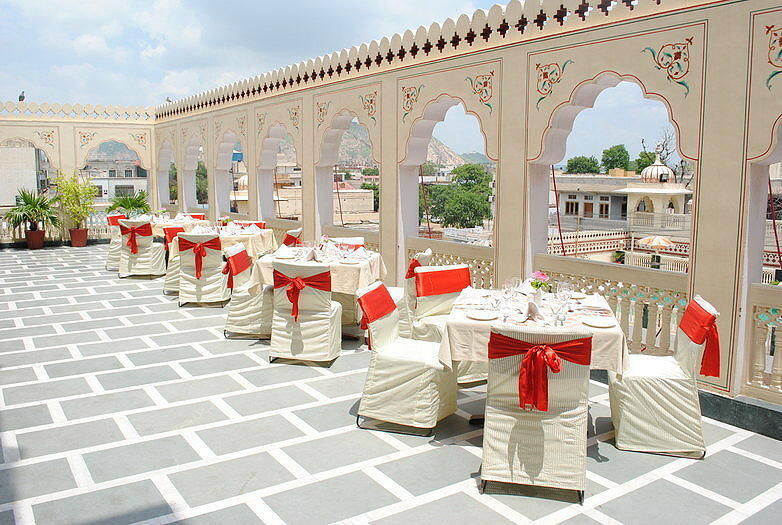 Rooftop restaurant terrace dining setup with city view at Fort Chandragupt Hotel Jaipur